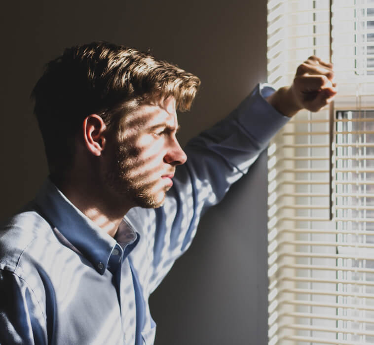depressed person looking out window