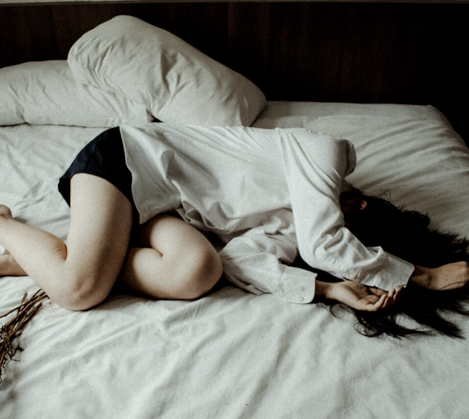 depressed person on a bed